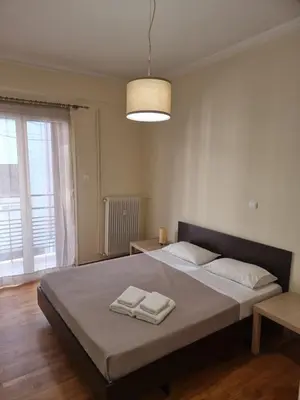 a bedroom with a large bed with two towels on it at athens.apartotel.3 in Athens