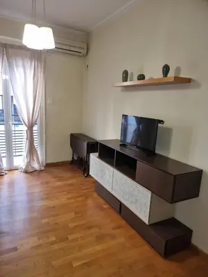 a living room with a tv and a desk at athens.apartotel.3 in Athens