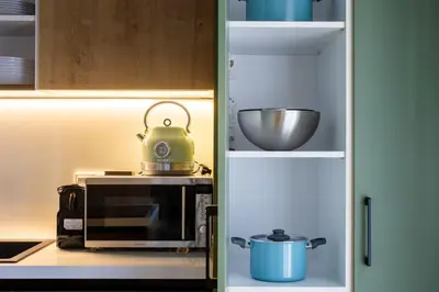 a tea kettle on top of a microwave in a kitchen at Mystique 2-Bedroom Apartment in Athens in Athens