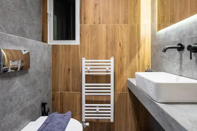 a bathroom with a sink and a toilet and a mirror at Mystique 2-Bedroom Apartment in Athens in Athens