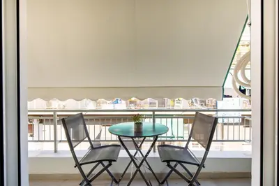 a table and chairs with a table and a balcony at Mystique 2-Bedroom Apartment in Athens in Athens