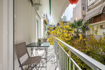 a balcony with a table and chairs and flowers at Mystique 2-Bedroom Apartment in Athens in Athens