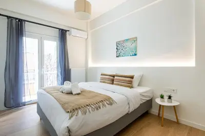 a bedroom with a large bed and a window at Mystique 2-Bedroom Apartment in Athens in Athens