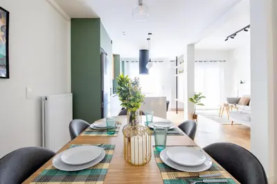 a dining room with a wooden table with chairs at Mystique 2-Bedroom Apartment in Athens in Athens