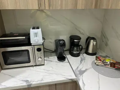 a microwave sitting on top of a counter at Four Seasons Apartment in Athens