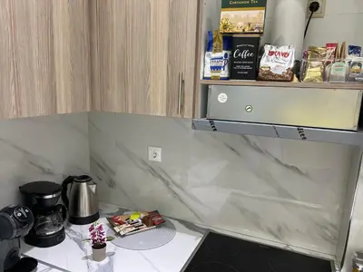 a kitchen with a counter top with a coffee maker at Four Seasons Apartment in Athens