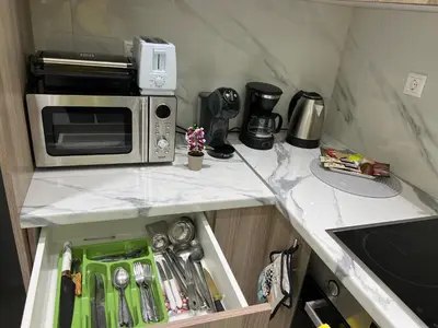 a kitchen with a microwave on a counter at Four Seasons Apartment in Athens