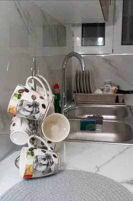a kitchen counter with a sink and a kitchen utensils at Four Seasons Apartment in Athens