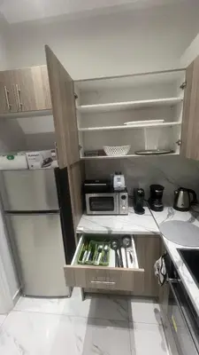 a small kitchen with a refrigerator and a microwave at Four Seasons Apartment in Athens