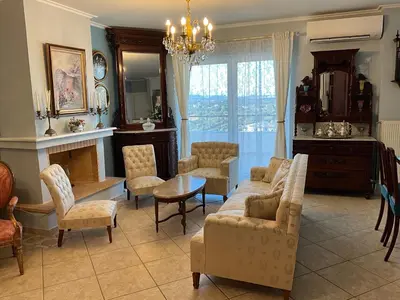 a living room with a couch and chairs and a table at VERA’S APARTMENT in Markopoulo