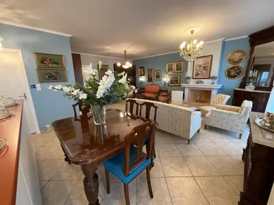 a living room with a table with flowers on it at VERA’S APARTMENT in Markopoulo