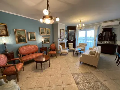a living room with couches and chairs at VERA’S APARTMENT in Markopoulo