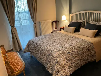 a bedroom with a large bed and a window at VERA’S APARTMENT in Markopoulo