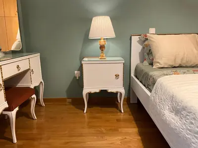a bedroom with a bed and a table with a lamp at VERA’S APARTMENT in Markopoulo