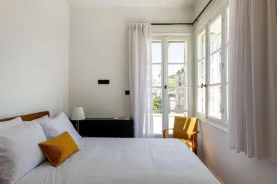 a bedroom with a bed and a large window at The Met by Zoia Living in Athens