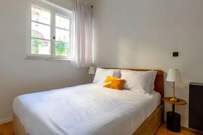 a bedroom with a white bed with a window at The Met by Zoia Living in Athens