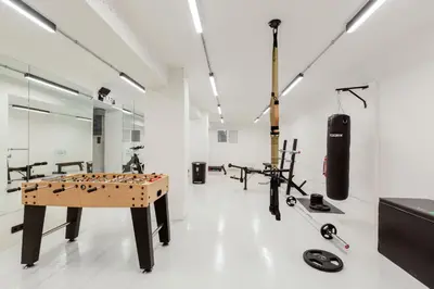 a room with a ping pong table and equipment in it at The Met by Zoia Living in Athens