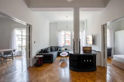a living room with a couch and a table at The Met by Zoia Living in Athens