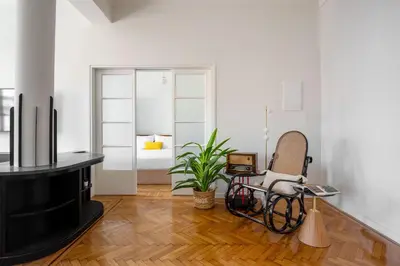 a living room with a chair and a television at The Met by Zoia Living in Athens