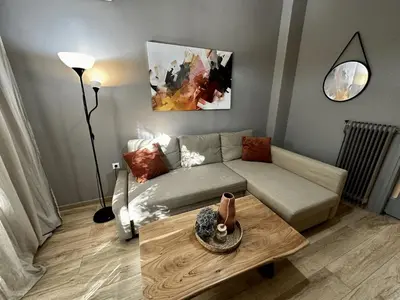 a living room with a couch and a coffee table at Your Cozy Home in Athens in Athens
