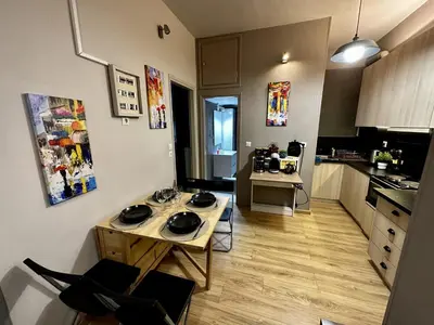 a small kitchen with a table in the middle of it at Your Cozy Home in Athens in Athens