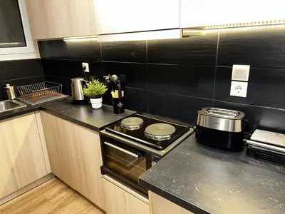 a kitchen with a stove and a counter top at Your Cozy Home in Athens in Athens