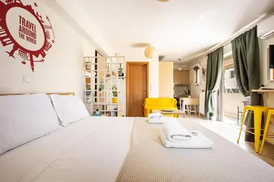 a bedroom with a large white bed with towels on it at Front-Row Acropolis View Balcony - Central Athens in Athens