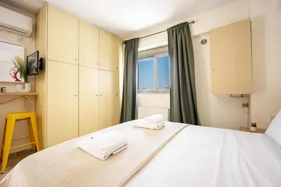 a bedroom with a bed with two towels on it at Front-Row Acropolis View Balcony - Central Athens in Athens
