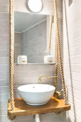 a bathroom with a white bowl sink on a wooden shelf at Stunning Acropolis View from a Sunny Renovated Apartment in Athens