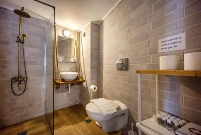 a bathroom with a toilet and a sink and a shower at Stunning Acropolis View from a Sunny Renovated Apartment in Athens