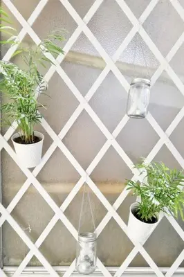 two potted plants on a shelf with a wall at Stunning Acropolis View from a Sunny Renovated Apartment in Athens