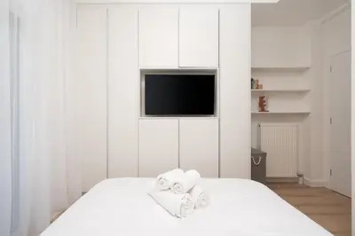 a white bedroom with towels on a bed at Exclusive and Deluxe Apartment in Athens City in Athens