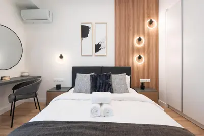 a bedroom with a bed with a desk and a chair at Exclusive and Deluxe Apartment in Athens City in Athens