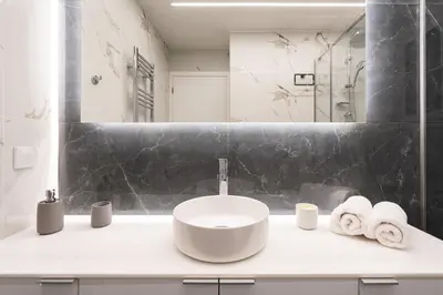 a bathroom with a sink with towels on a counter at Exclusive and Deluxe Apartment in Athens City in Athens