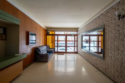 a living room with a chair and a television at Exclusive and Deluxe Apartment in Athens City in Athens