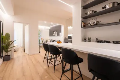 a kitchen and living room with a bar with stools at Exclusive and Deluxe Apartment in Athens City in Athens