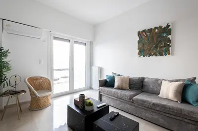 a living room with a couch and a table at Sunny n Luxury apt in Glyfadas center in Athens