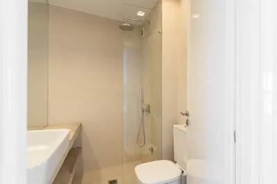 a white bathroom with a toilet and a sink at Contemporary Bliss 2BR Apartment in Athens by UPSTREET in Athens