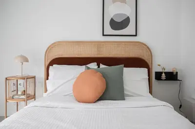 a bed with a large orange ball on top of it at Contemporary Bliss 2BR Apartment in Athens by UPSTREET in Athens
