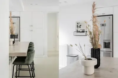 a kitchen and dining room with a table and chairs at Contemporary Bliss 2BR Apartment in Athens by UPSTREET in Athens