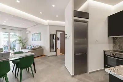a kitchen and living room with a table and chairs at Nature-Infused Vibes & Nightlife in Athens
