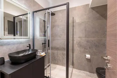 a bathroom with a sink and a shower at Nature-Infused Vibes & Nightlife in Athens