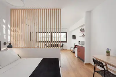 a bedroom with a bed and a desk in a room at Syntagma Unique Penthouse in Athens