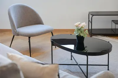 a coffee table with a vase of flowers on it at Syntagma Unique Penthouse in Athens