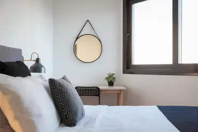 a bedroom with a bed with a mirror on the wall at Syntagma Unique Penthouse in Athens