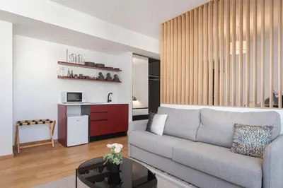 a living room with a couch and a table at Syntagma Unique Penthouse in Athens
