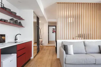 a kitchen and a living room with a couch at Syntagma Unique Penthouse in Athens
