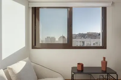 a living room with a couch and a window at Syntagma Unique Penthouse in Athens