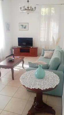 a living room with a blue couch and a table at Calliope's Neoclassical Home in the heart of Plaka in Athens