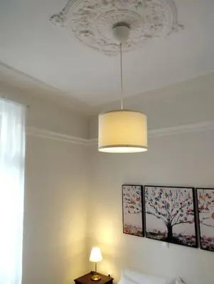 a bedroom with a ceiling with a chandelier above a bed at Calliope's Neoclassical Home in the heart of Plaka in Athens